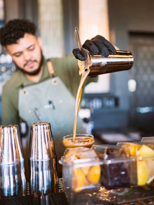 Our bartenders at Lakeshore Kitchen & Cocktail are behind the bar mixing,…